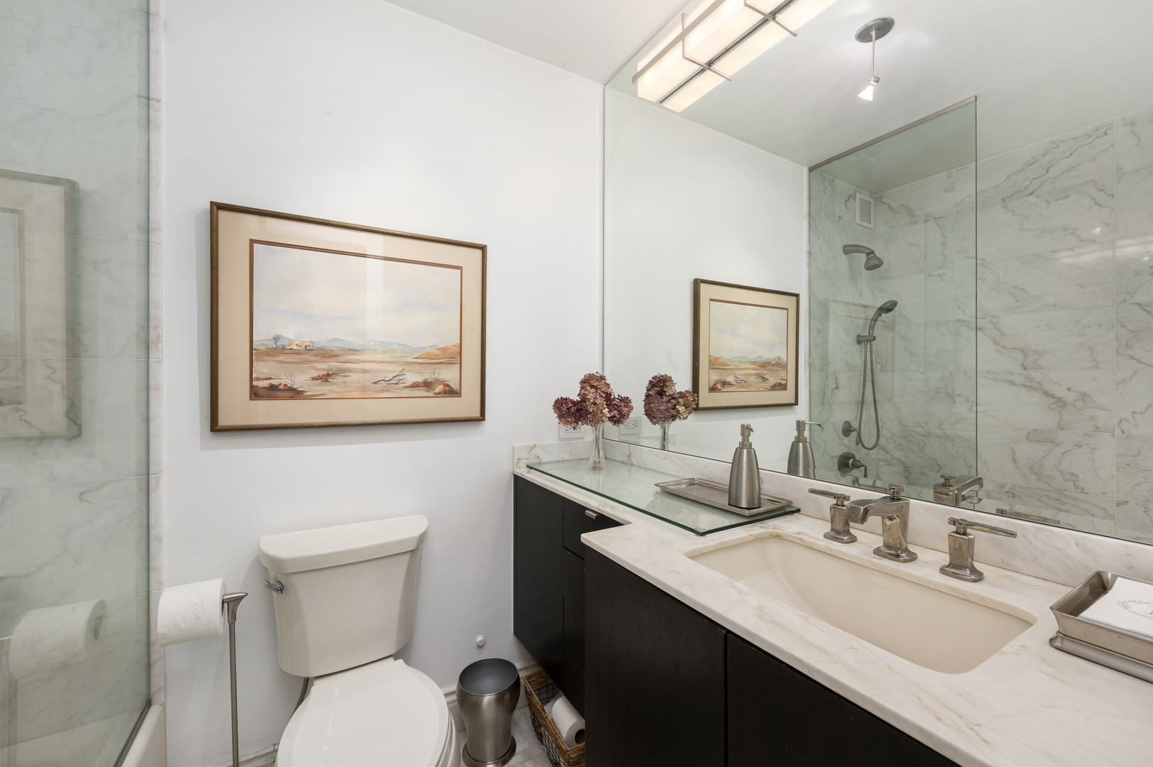 1325 North State Parkway, Unit 16B Chicago, IL 60610 - Photo 30 of 35 a bathroom with a toilet a sink and mirror