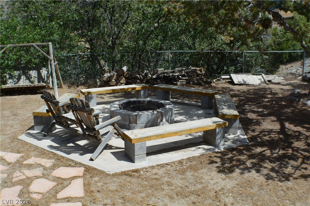1321 Trout Canyon Road Las Vegas, NV 89124 - Photo 7 of 50 Gather around this private fire pit, surrounded by built-in seating for convivial evenings under the stars.