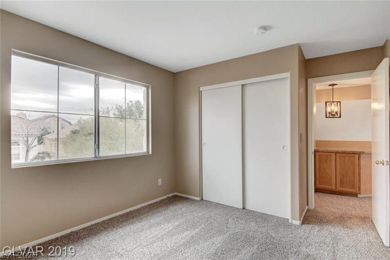 2647 Ridgewater Circle Henderson, NV 89074 - Photo 17 of 26 A well-proportioned space features plush carpeting, a wide window, and a sliding-door closet.