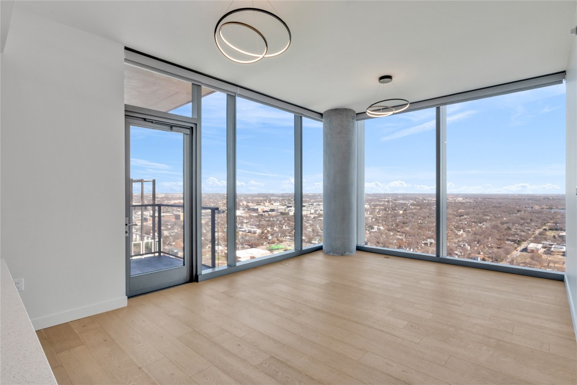 44 East Avenue, Unit 3107 Austin, TX 78701 - Photo 11 of 40 wooden floor in an empty room with a window