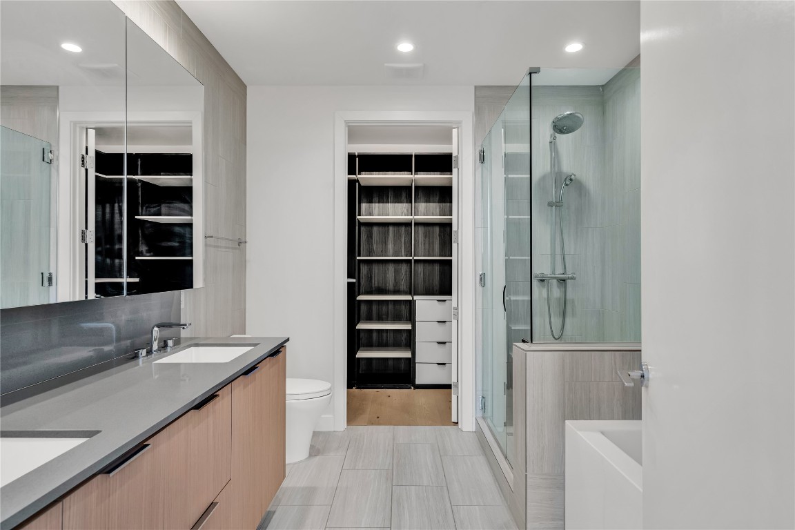 44 East Avenue, Unit 3107 Austin, TX 78701 - Photo 23 of 40 a bathroom with a double vanity sink a and a shower