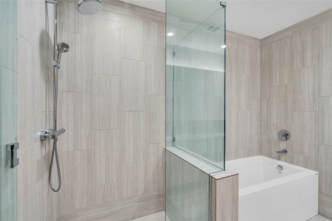 44 East Avenue, Unit 3107 Austin, TX 78701 - Photo 27 of 40 a bathroom with a tub and shower