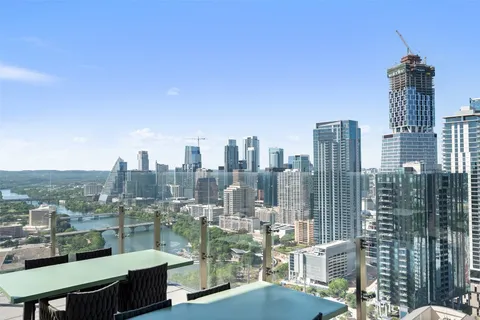 a large living room with large couches and flat screen tv