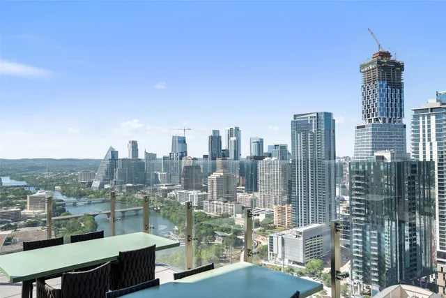 a large living room with large couches and flat screen tv