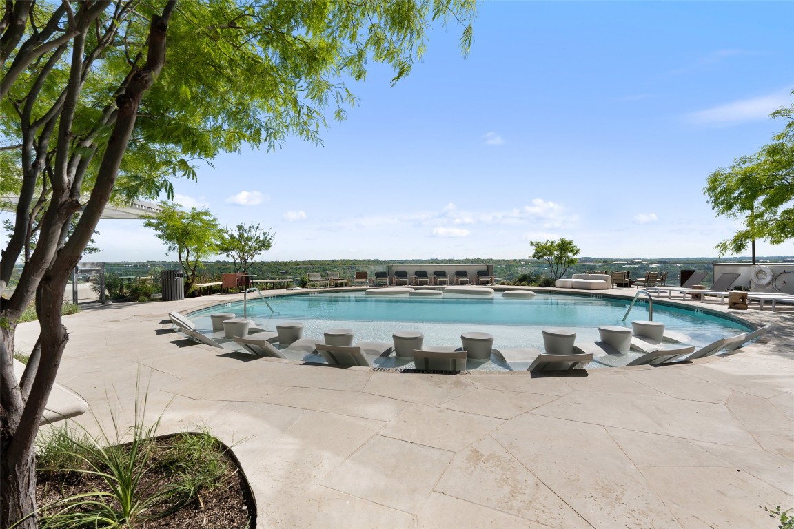 44 East Avenue, Unit 3107 Austin, TX 78701 - Photo 38 of 40 a view of a swimming pool with outdoor seating and plants
