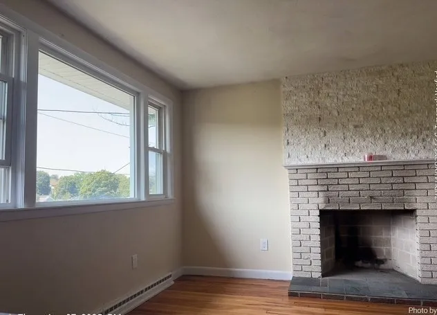 a living room with a fireplace and a window