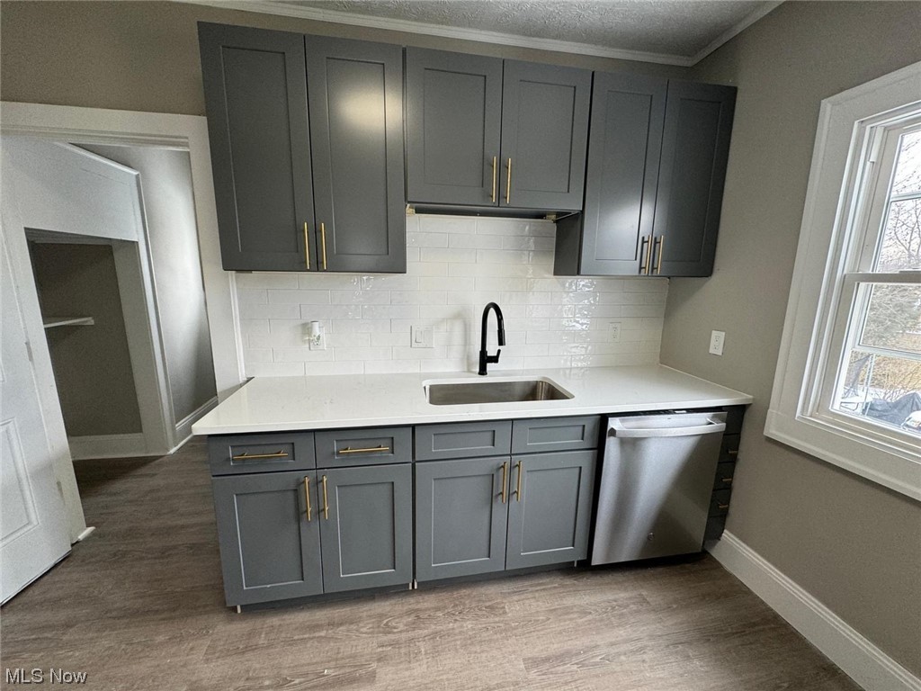 3333 Berea Road Cleveland, OH 44111 - Photo 14 of 34 Kitchen with sink, stainless steel dishwasher, light wood-type flooring, and a wealth of natural light