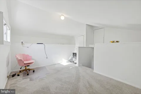 a room with a chair and white walls