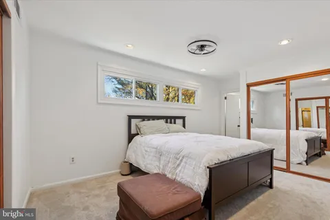 a bedroom with a bed and painting on the wall