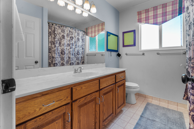 5727 South 3550th Street West Roy, UT 84067 - Photo 13 of 49 Full guest bathroom, vanity with a white countertop and a single basin sink
