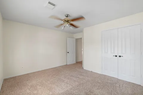 a view of a room with a ceiling fan