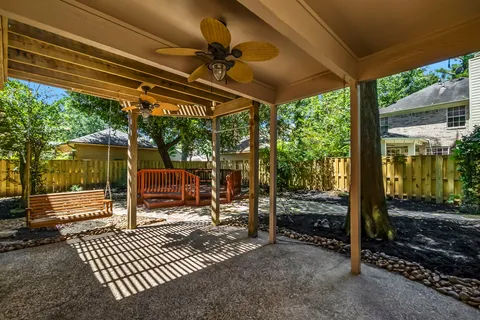 a view of a wooden deck with a large trees