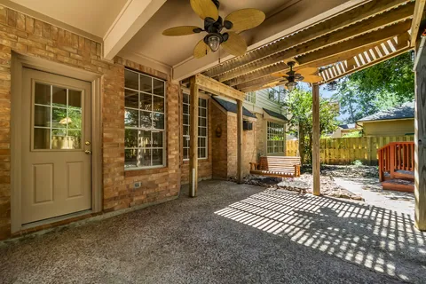 a view of a brick house with large windows