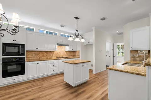 a kitchen with granite countertop a stove oven and a sink with granite countertops