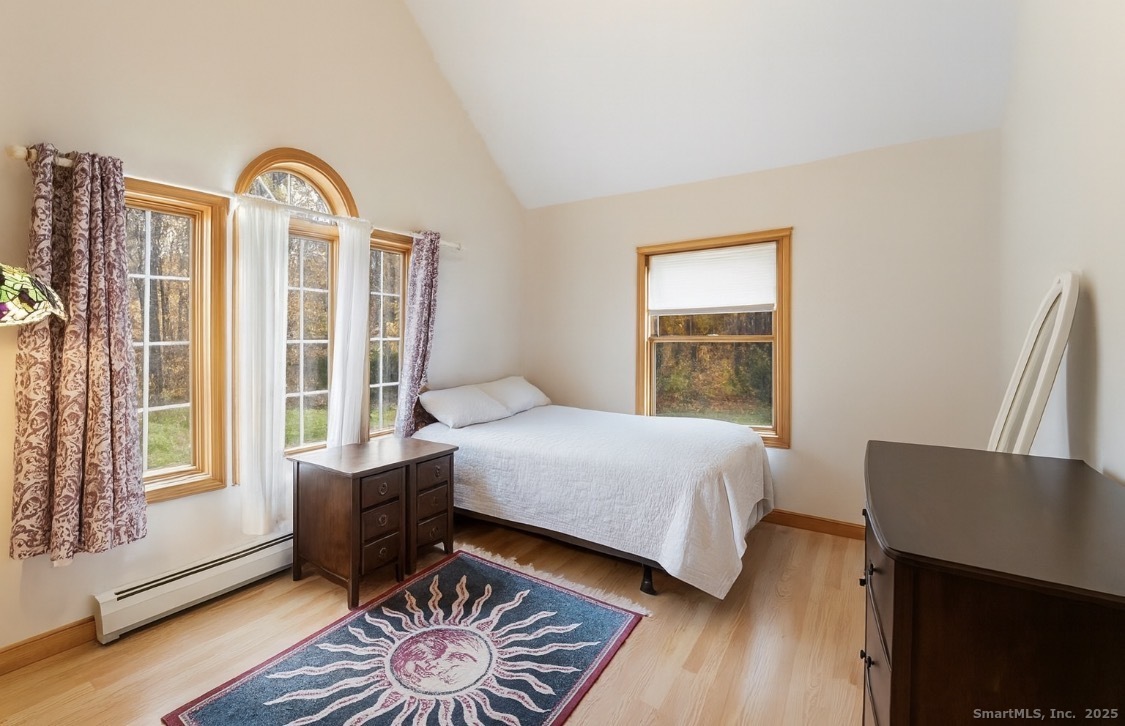 63 Buck Hill Road Canterbury, CT 06331 - Photo 13 of 25 a bedroom with a bed and wooden floor