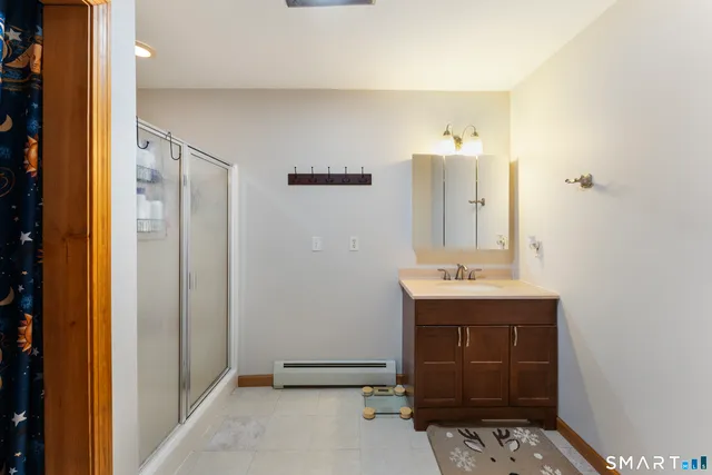 a bathroom with a granite countertop sink a toilet and a mirror