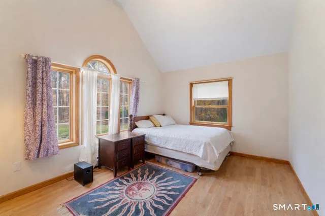 a bedroom with a bed and window