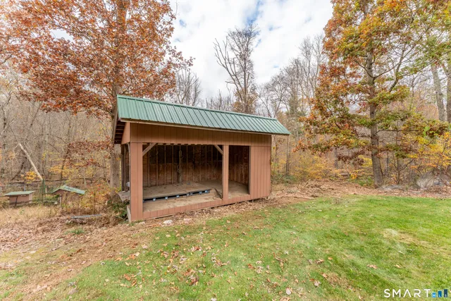 a view of a multi story residential apartment building with a yard