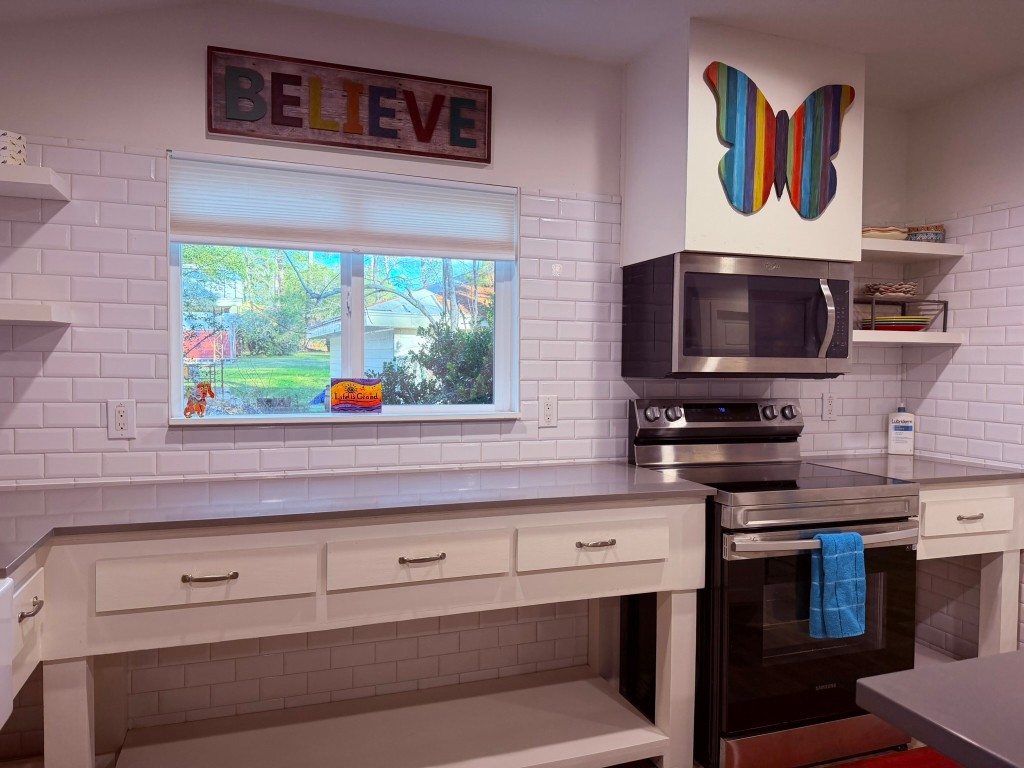 251 County Road Goodrich, TX 77335 - Photo 13 of 50 a kitchen with a stove and a microwave