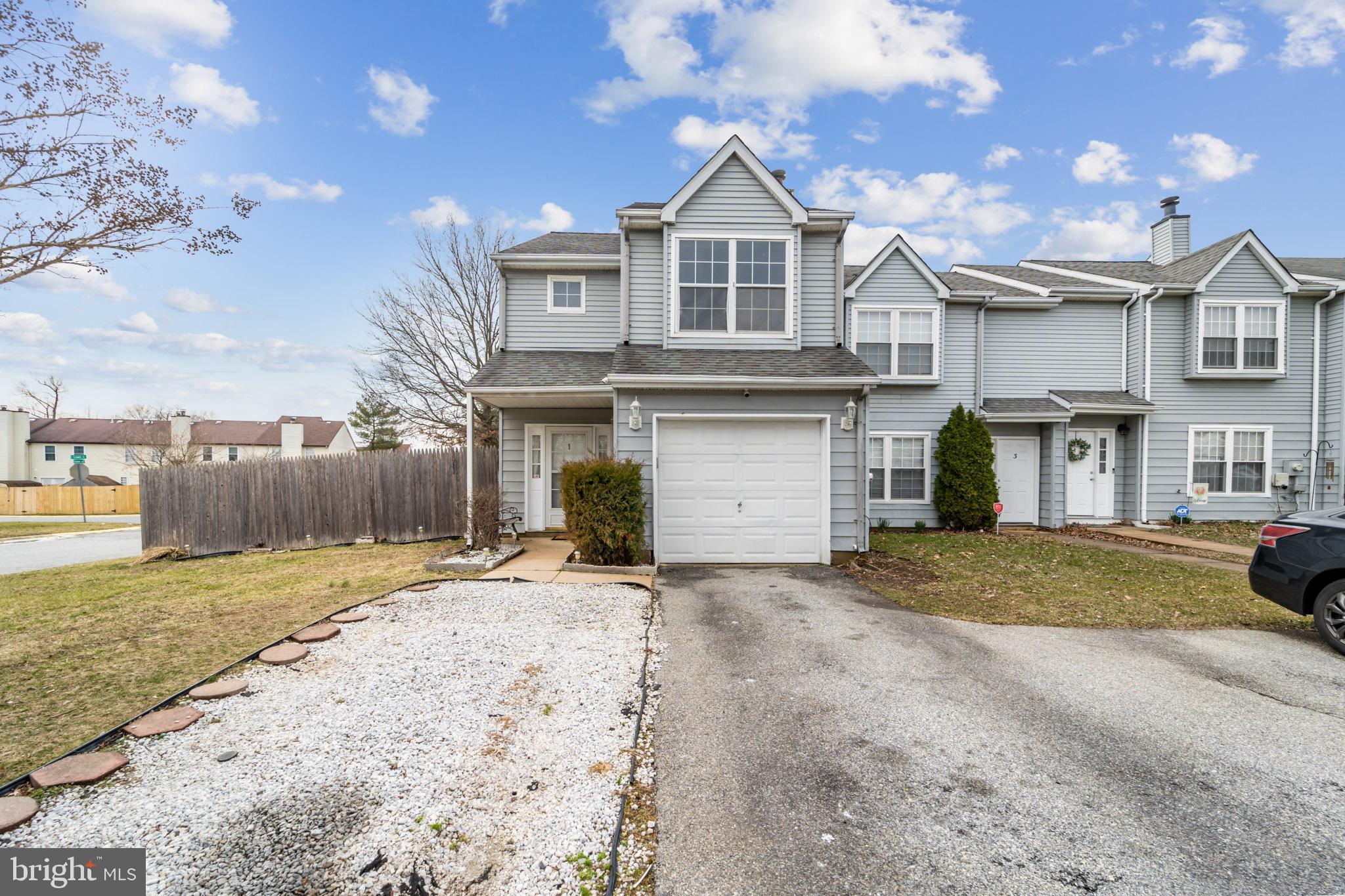 a view of a house with a yard and garage