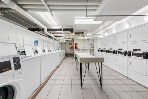 a kitchen with stainless steel appliances granite countertop a sink and white cabinets