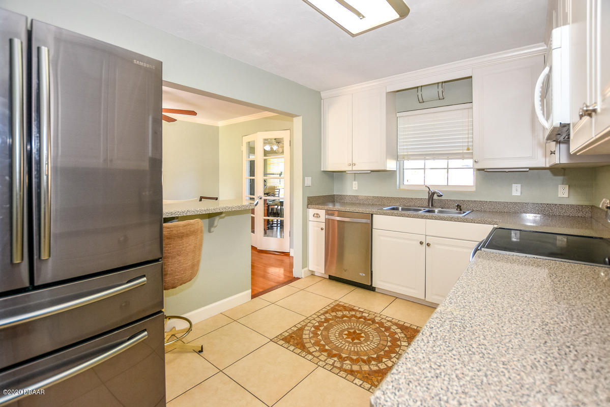 1509 Ridge Avenue Holly Hill, FL 32117 - Photo 16 of 40 a kitchen with a sink appliances cabinets and a counter top space
