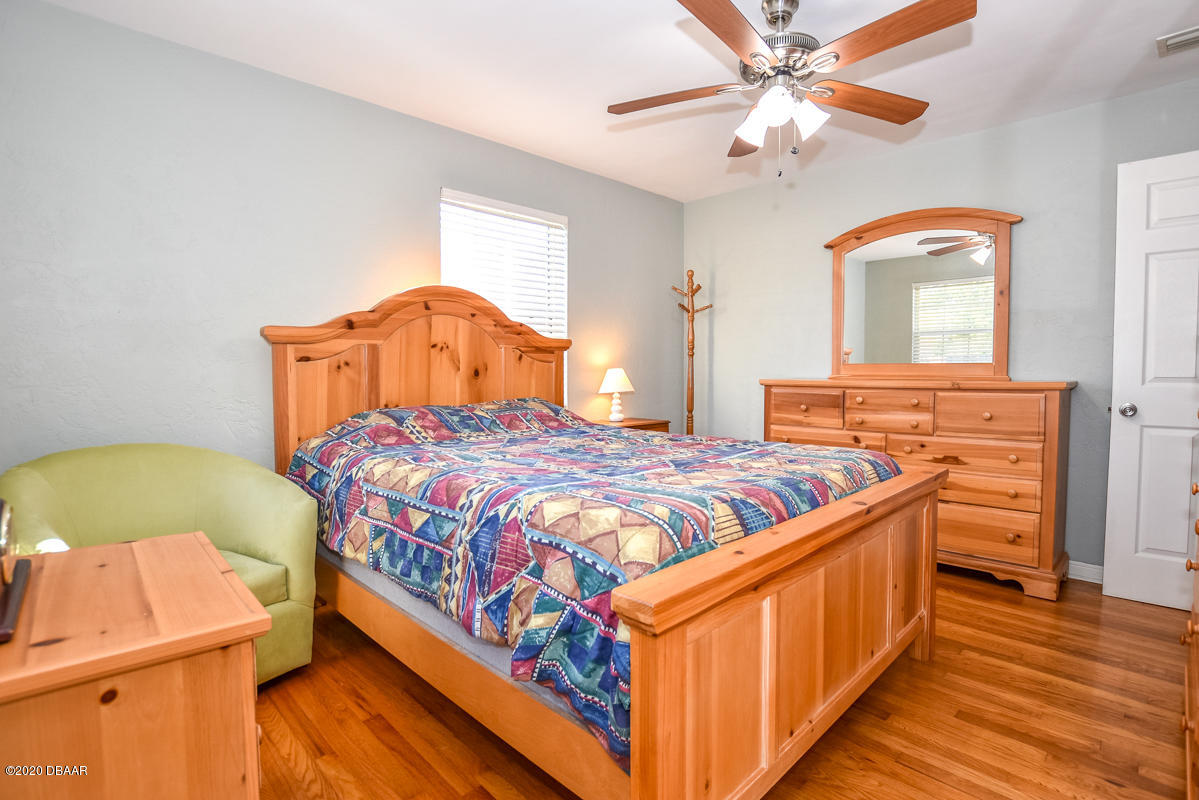 1509 Ridge Avenue Holly Hill, FL 32117 - Photo 17 of 40 a bedroom with a bed and a dresser