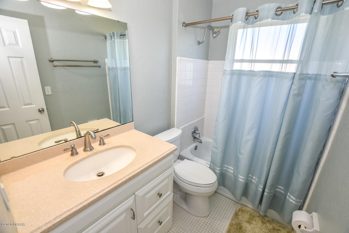 1509 Ridge Avenue Holly Hill, FL 32117 - Photo 21 of 40 a bathroom with a sink a toilet and shower