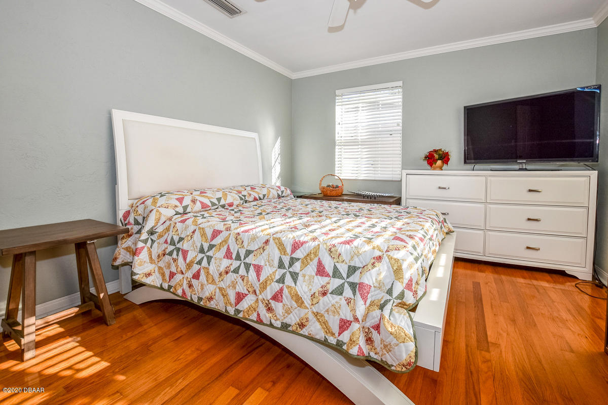 1509 Ridge Avenue Holly Hill, FL 32117 - Photo 23 of 40 a bedroom with a bed and flat screen tv