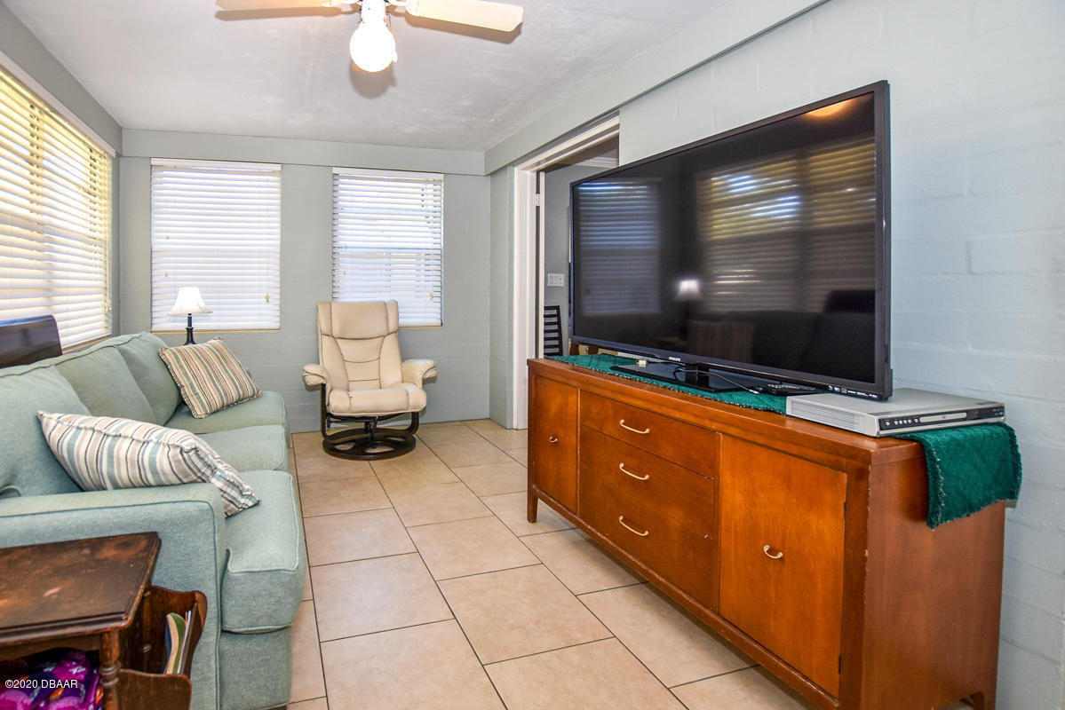 1509 Ridge Avenue Holly Hill, FL 32117 - Photo 28 of 40 a living room with furniture and a flat screen tv