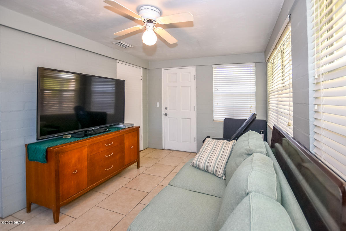 1509 Ridge Avenue Holly Hill, FL 32117 - Photo 30 of 40 a living room with furniture and a flat screen tv