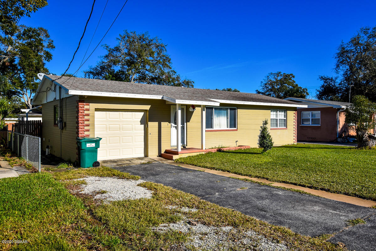 1509 Ridge Avenue Holly Hill, FL 32117 - Photo 3 of 40 a view of a house with a small yard and a large tree