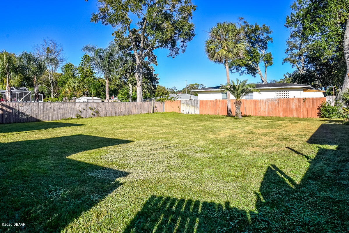 1509 Ridge Avenue Holly Hill, FL 32117 - Photo 32 of 40 a view of yard with swimming pool and trees