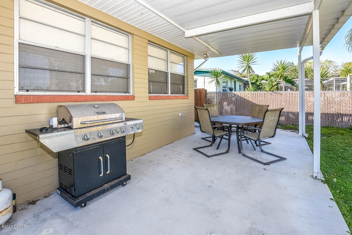 1509 Ridge Avenue Holly Hill, FL 32117 - Photo 34 of 40 a view of a patio with table and chairs