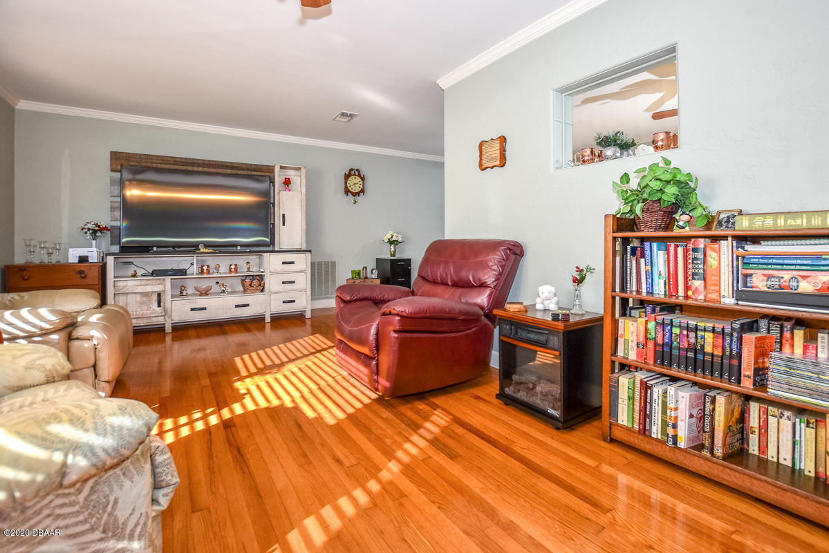 1509 Ridge Avenue Holly Hill, FL 32117 - Photo 5 of 40 a living room with furniture and a flat screen tv