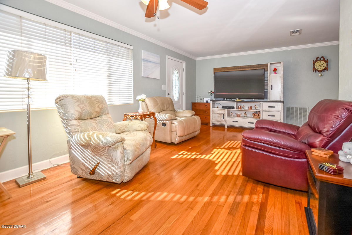 1509 Ridge Avenue Holly Hill, FL 32117 - Photo 6 of 40 a living room with furniture and a flat screen tv