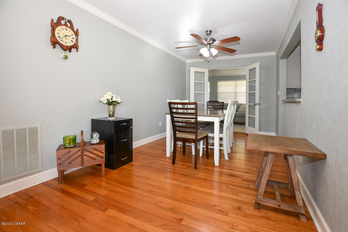 1509 Ridge Avenue Holly Hill, FL 32117 - Photo 9 of 40 a dining room with furniture a rug and wooden floor