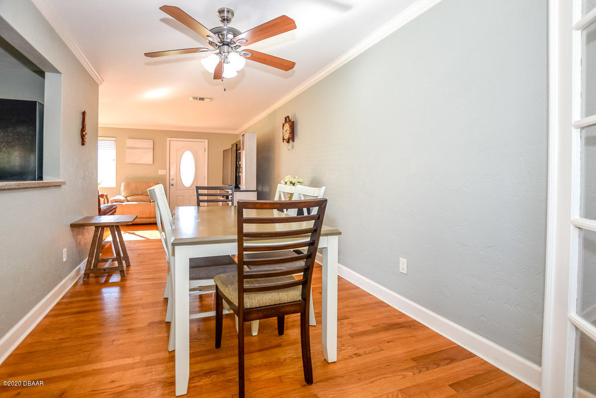 1509 Ridge Avenue Holly Hill, FL 32117 - Photo 10 of 40 a dining room with furniture a chandelier and wooden floor