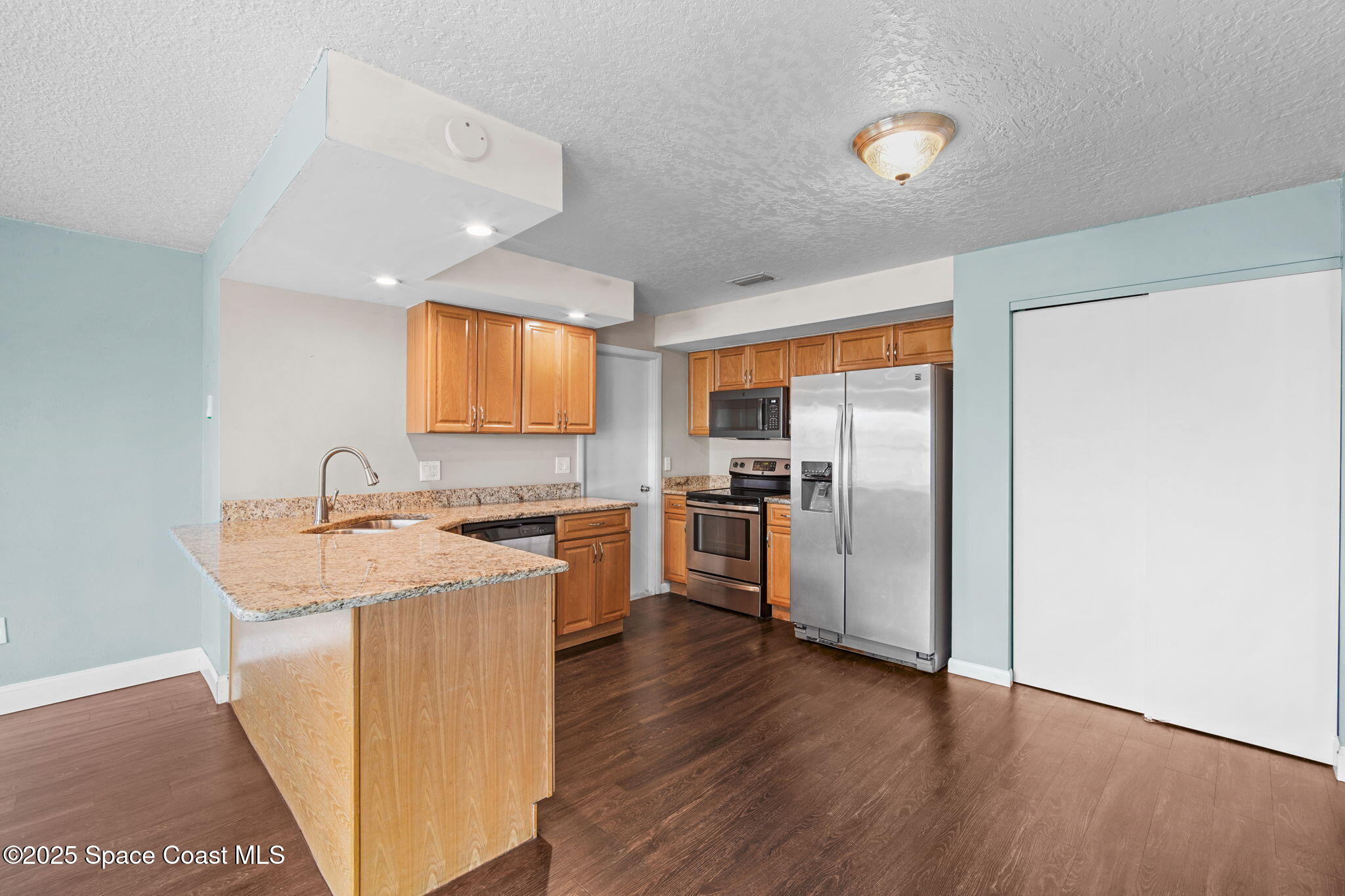 520 Croton Road Melbourne, FL 32935 - Photo 11 of 36 a kitchen with a refrigerator sink and stove