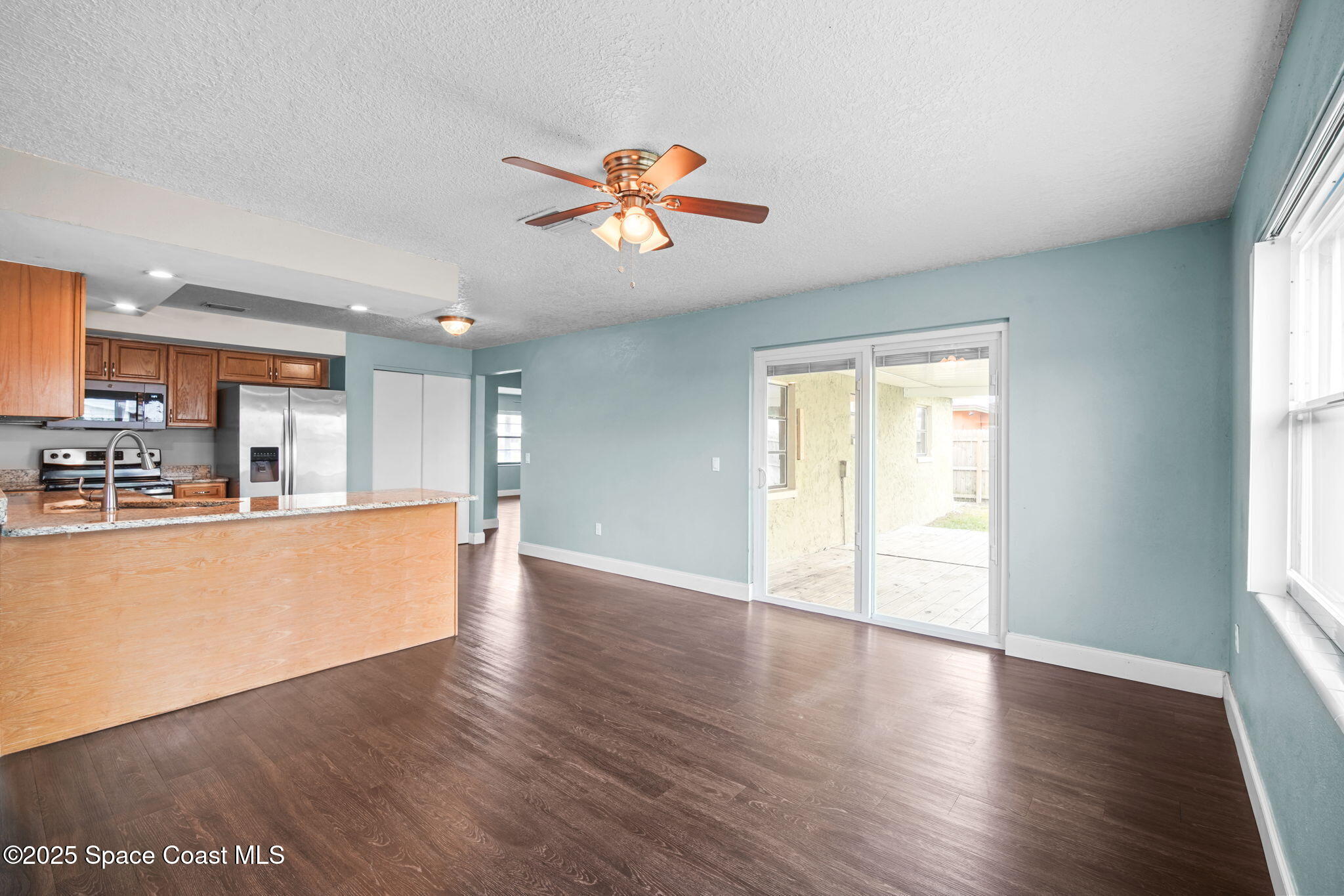 520 Croton Road Melbourne, FL 32935 - Photo 14 of 36 a view of a kitchen with wooden floor and a window
