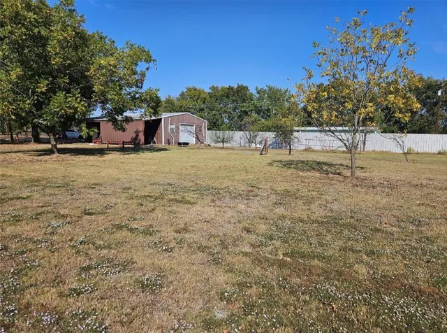 a backyard of a house with trees and outdoor space