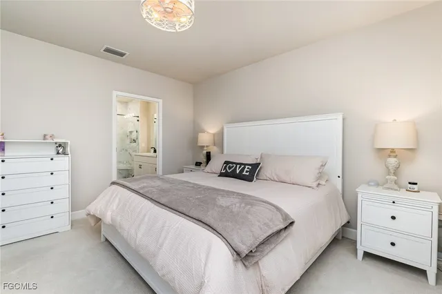 a bedroom with a bed and a lamp