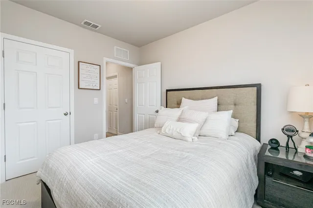 a bedroom with a bed and a lamp