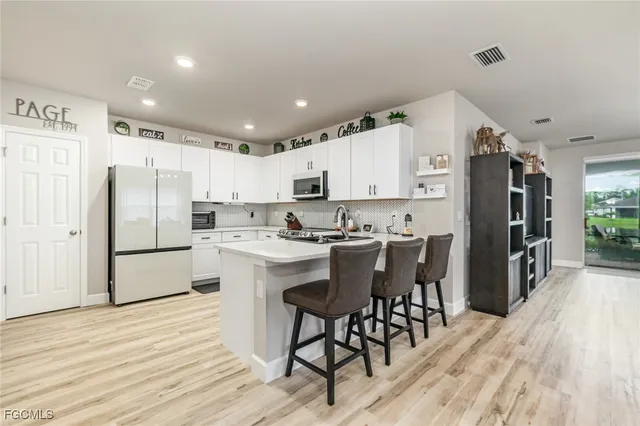 a kitchen with stainless steel appliances a refrigerator stove microwave and cabinets