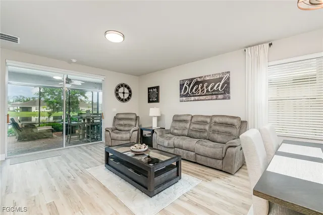 a living room with furniture and a floor to ceiling window