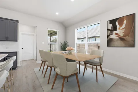 a view of a dining room with furniture and window