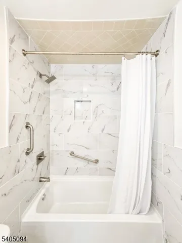 a bathroom with a bathtub and shower