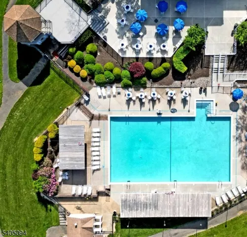 an aerial view of a house with a garden and outdoor seating