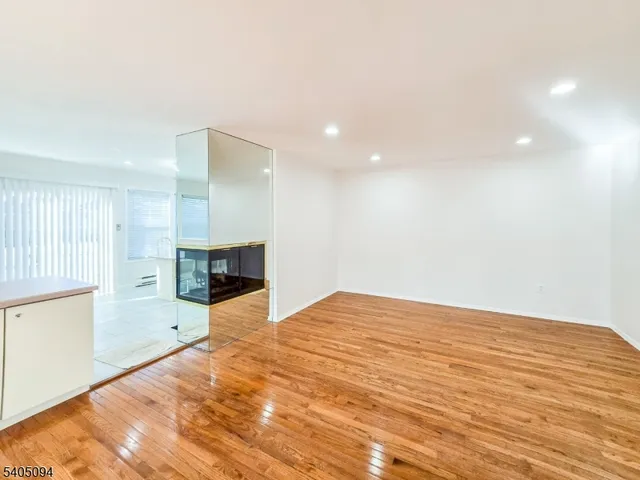 a view of an empty room with a fireplace and a window