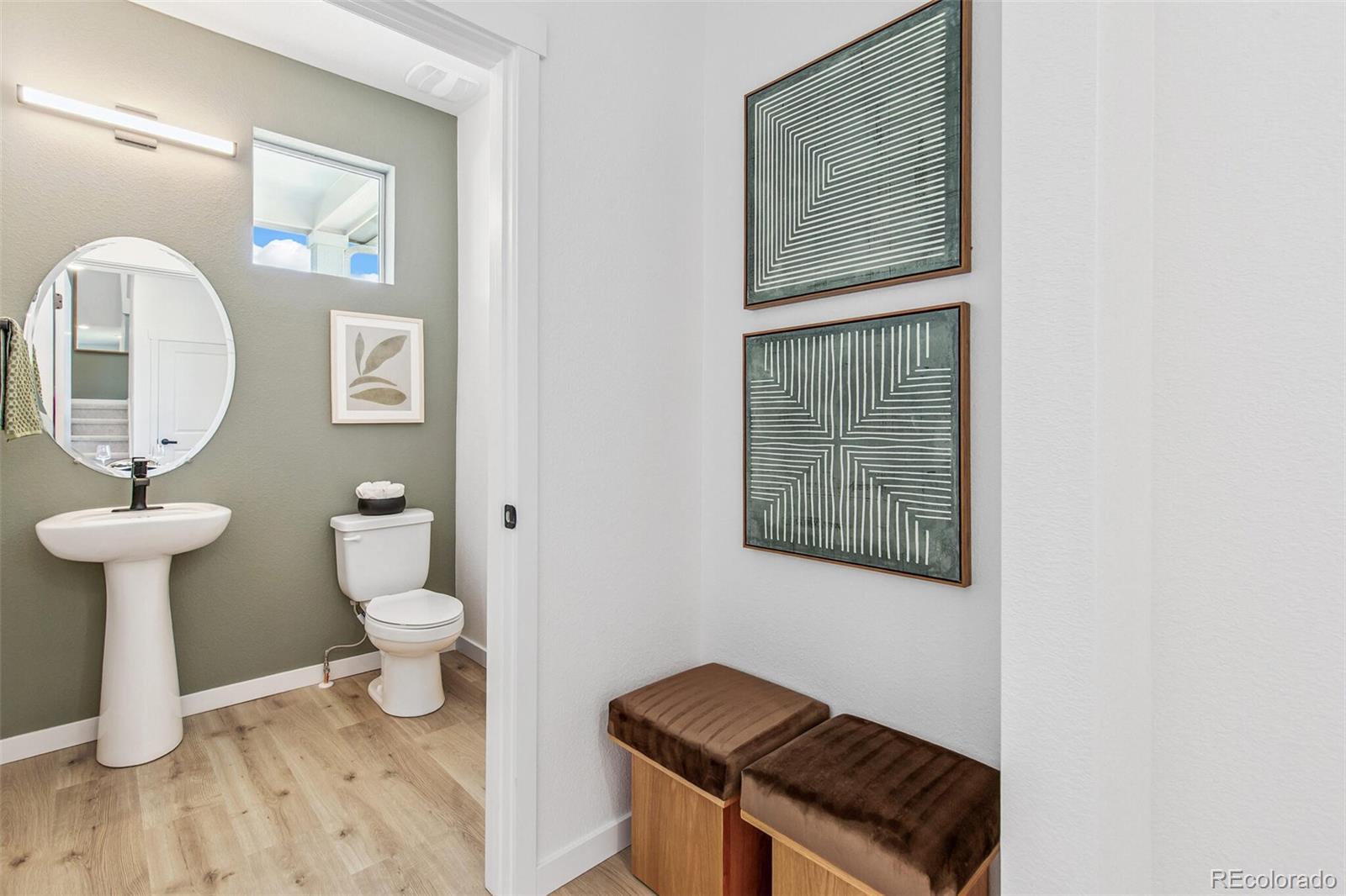 1374 South Chester Street, Unit A Denver, CO 80247 - Photo 18 of 35 a bathroom with a toilet a sink and mirror